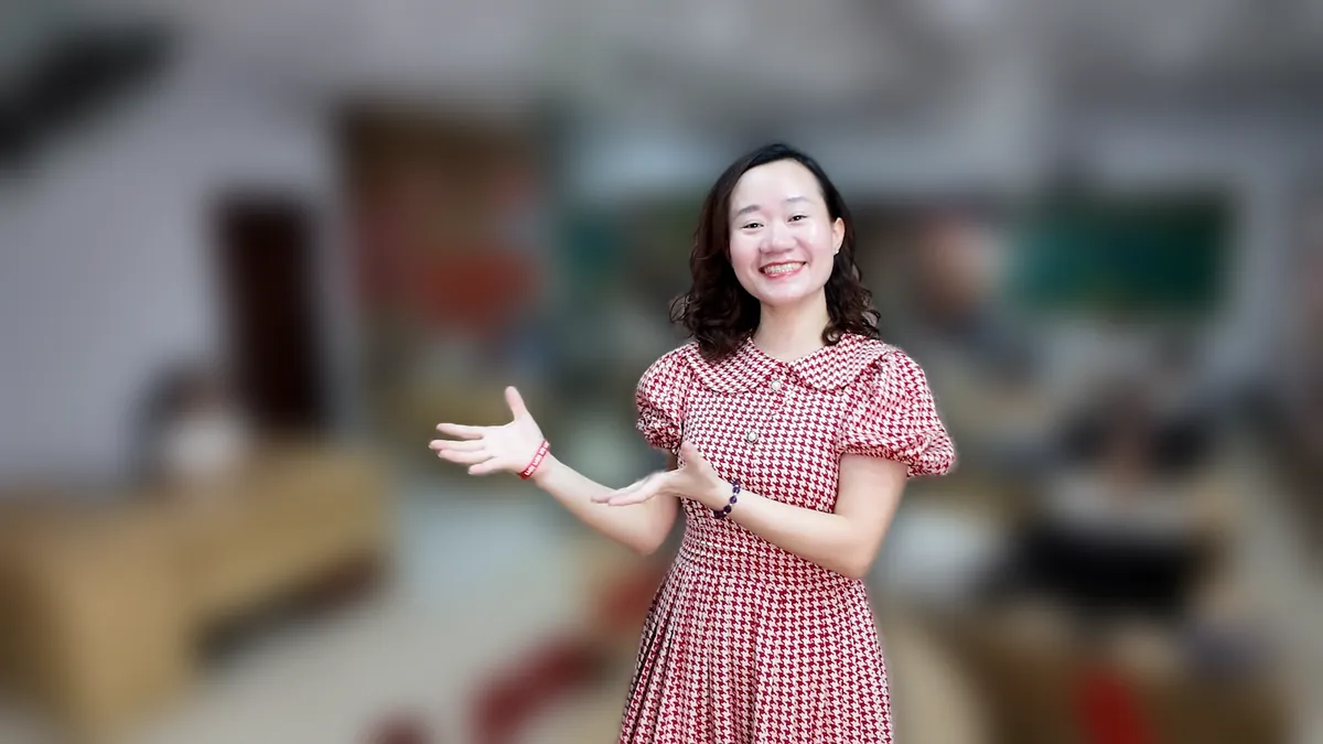 Chị Thảo Nguyễn váy caro đỏ đưa hai tay như giới thiệu, mỉm cười tại văn phòng Tâm - Tầm - Tài – chia sẻ về chi phí thành lập công ty cổ phần