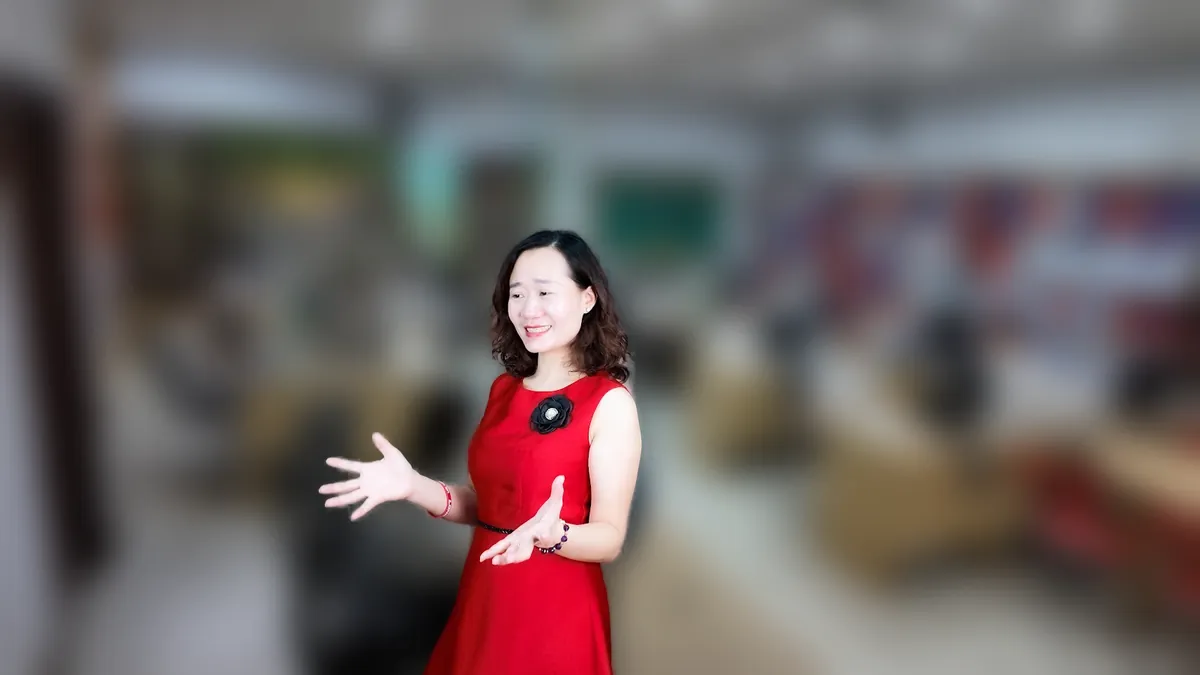 Chị Thảo Nguyễn váy đỏ đưa tay như giới thiệu, mỉm cười tại văn phòng Tâm - Tầm - Tài – chia sẻ về mẫu điều lệ công ty tnhh 1 thành viên 2026