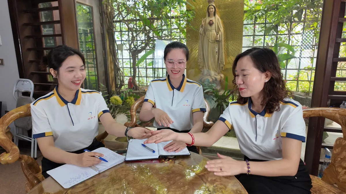 Chị Thảo Nguyễn trao đổi công việc với hai nhân viên bên bàn tròn tại Tâm - Tầm - Tài – chia sẻ về quy định dạy thêm học thêm