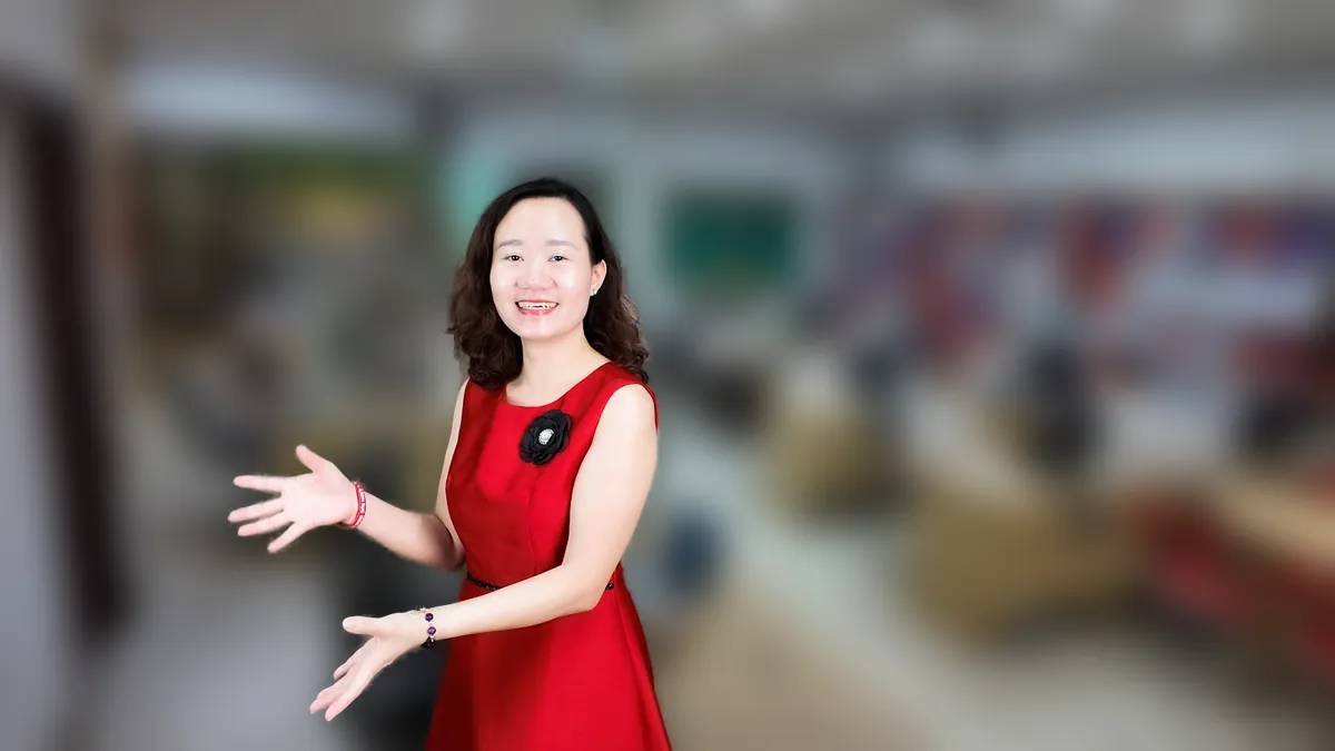 Chị Thảo Nguyễn váy đỏ đưa tay như giới thiệu, mỉm cười tại văn phòng Tâm - Tầm - Tài – chia sẻ về đăng ký hộ kinh doanh trên vneid