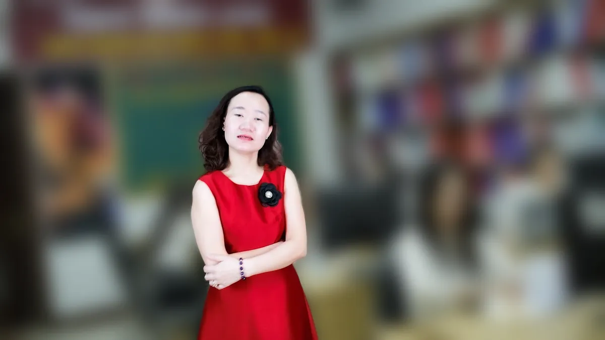 Chị Thảo Nguyễn váy caro đỏ đưa hai tay như giới thiệu, mỉm cười tại văn phòng Tâm - Tầm - Tài – chia sẻ về quy trình tuyển dụng nhân sự